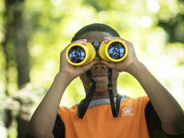 Boy looking through binoculars