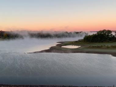 Mist over DeGray lake during sunrise.