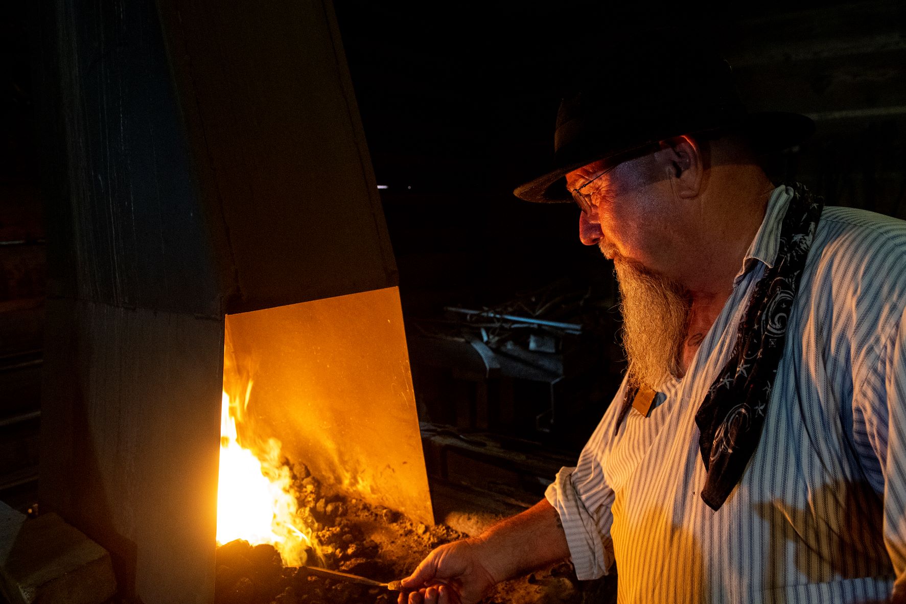 Blacksmith at Historic Washington State Park using the forge