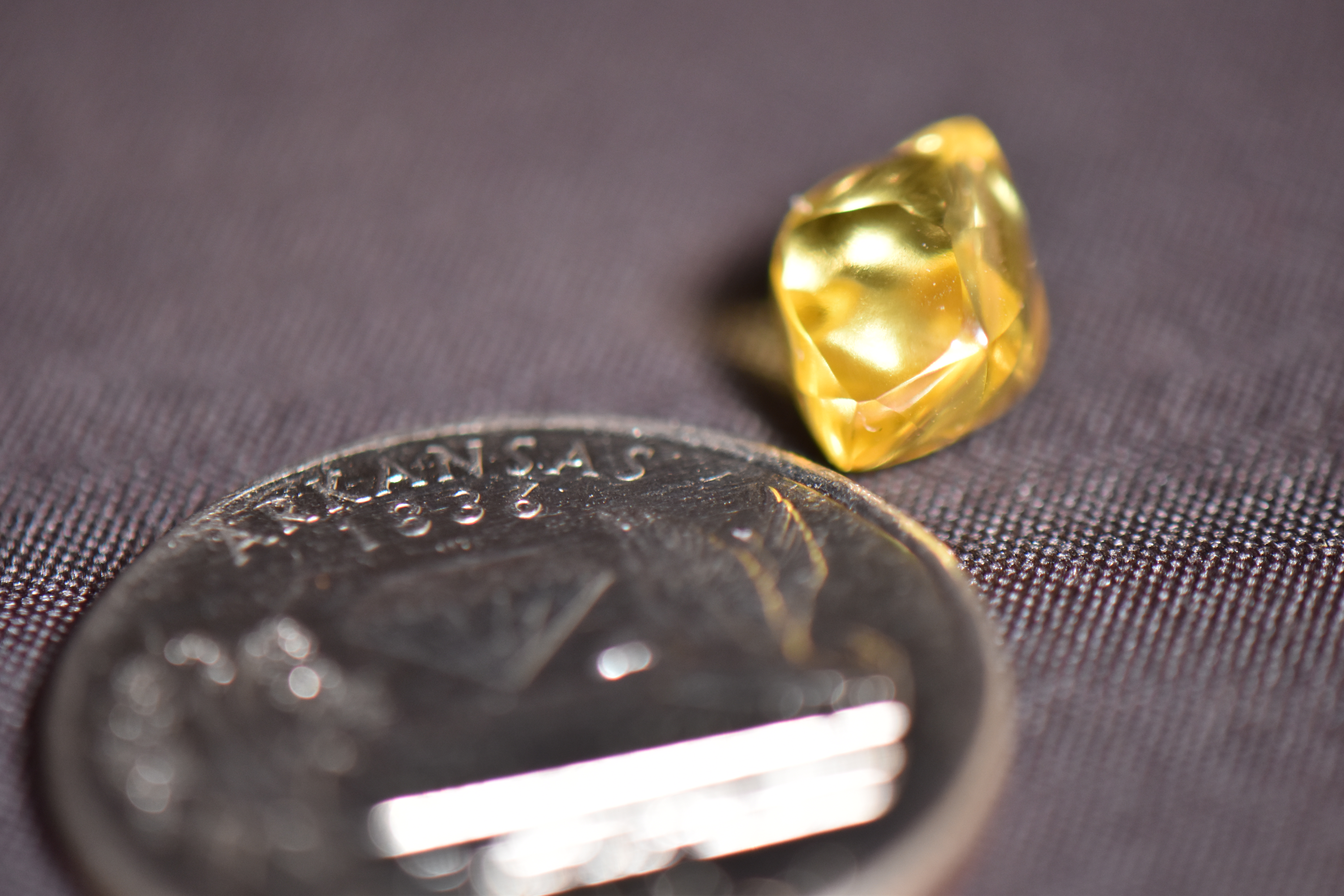 Steven McCool 4.49-Carat yellow diamond next to a quarter for scale