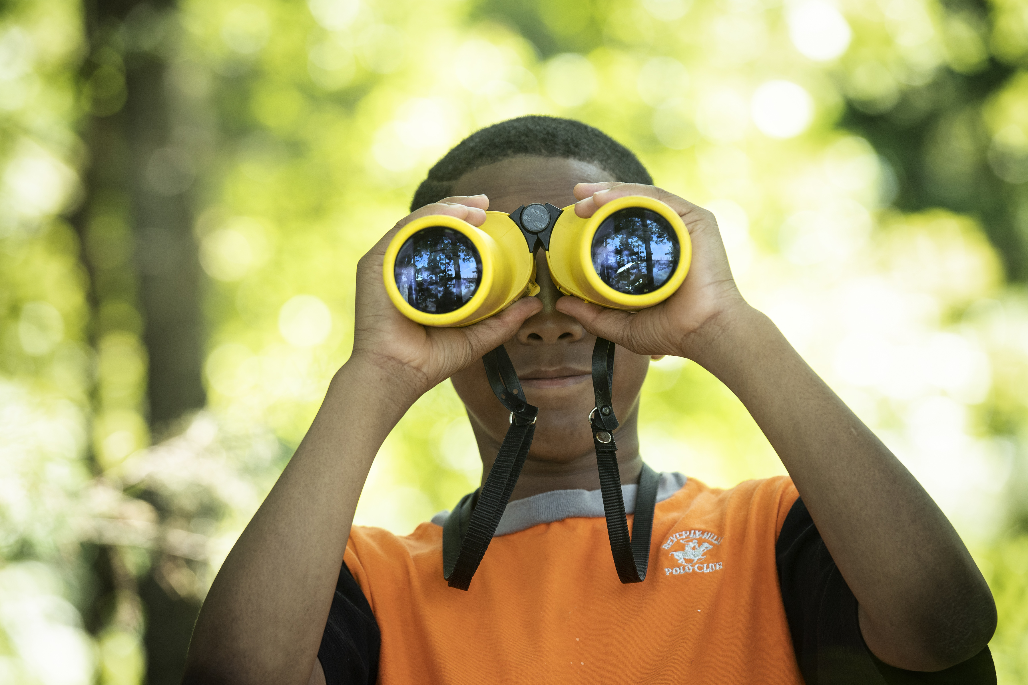 Boy looking through binoculars