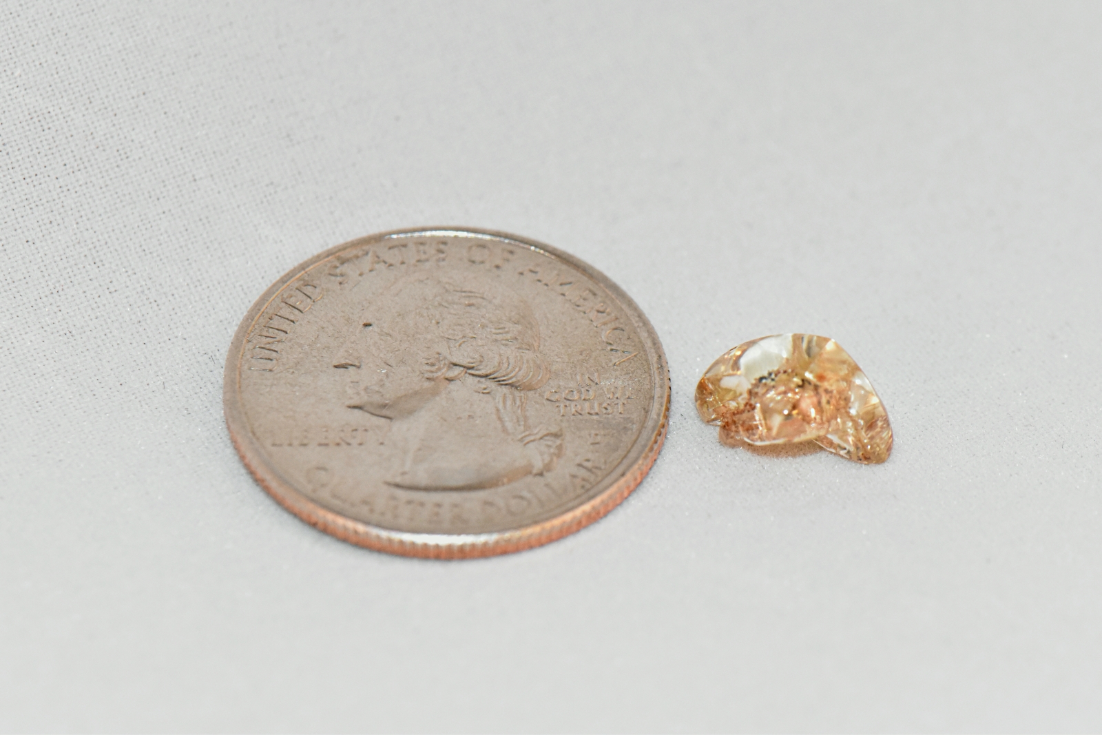 Caro Avenger diamond next to a quarter for scale