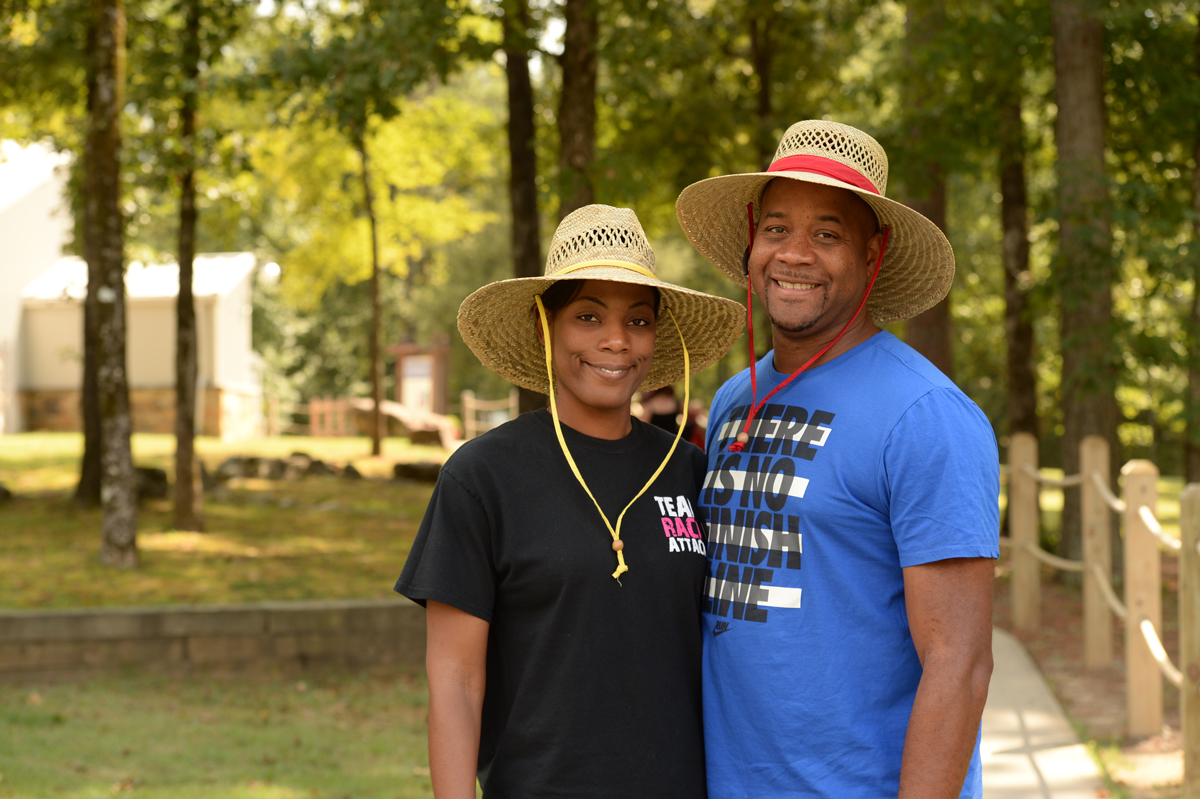 Couple wearing wide brimmed hat to dig for diamonds