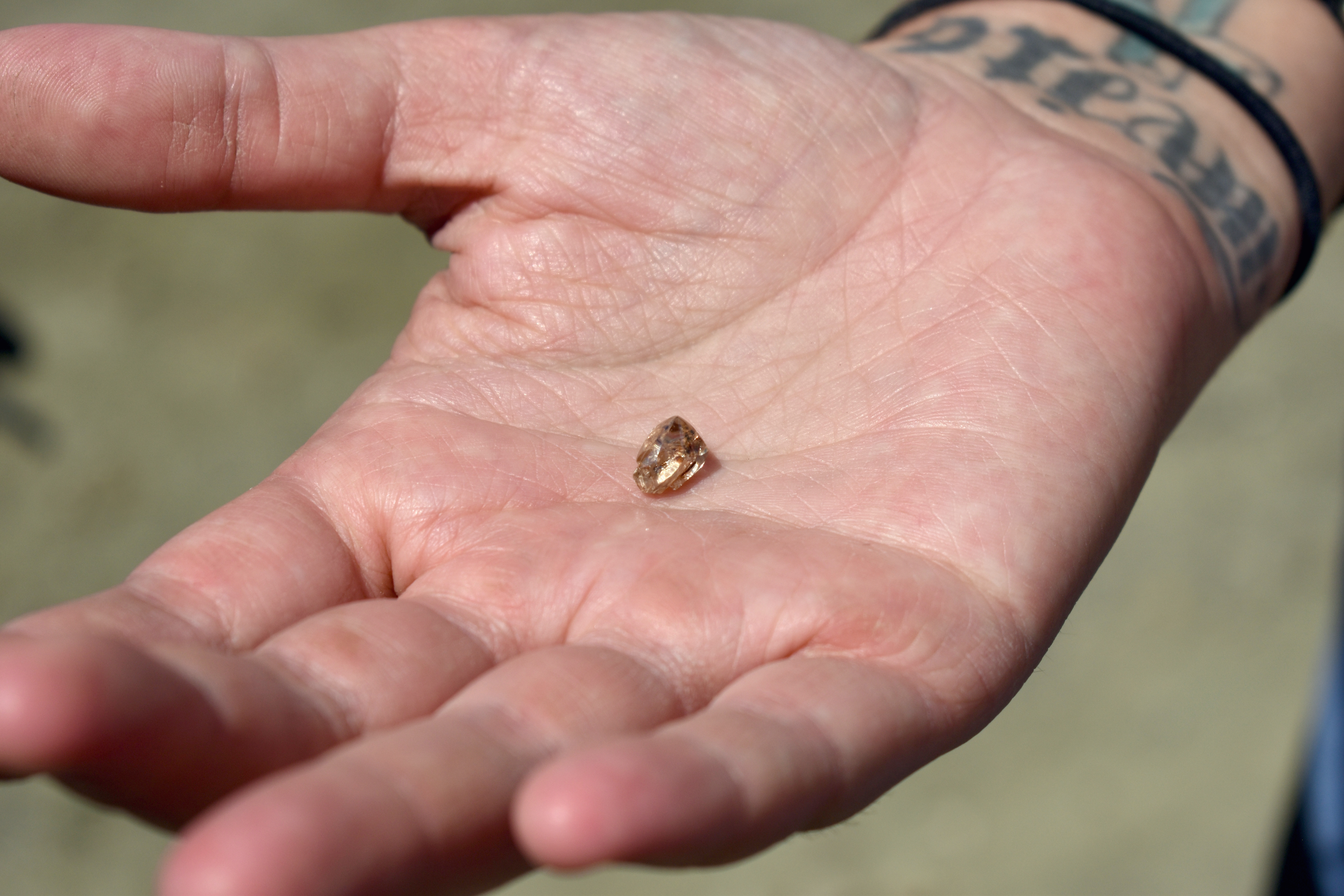 Miranda Hollingshead holds her 3.72-carat yellow diamond in the palm of her hand