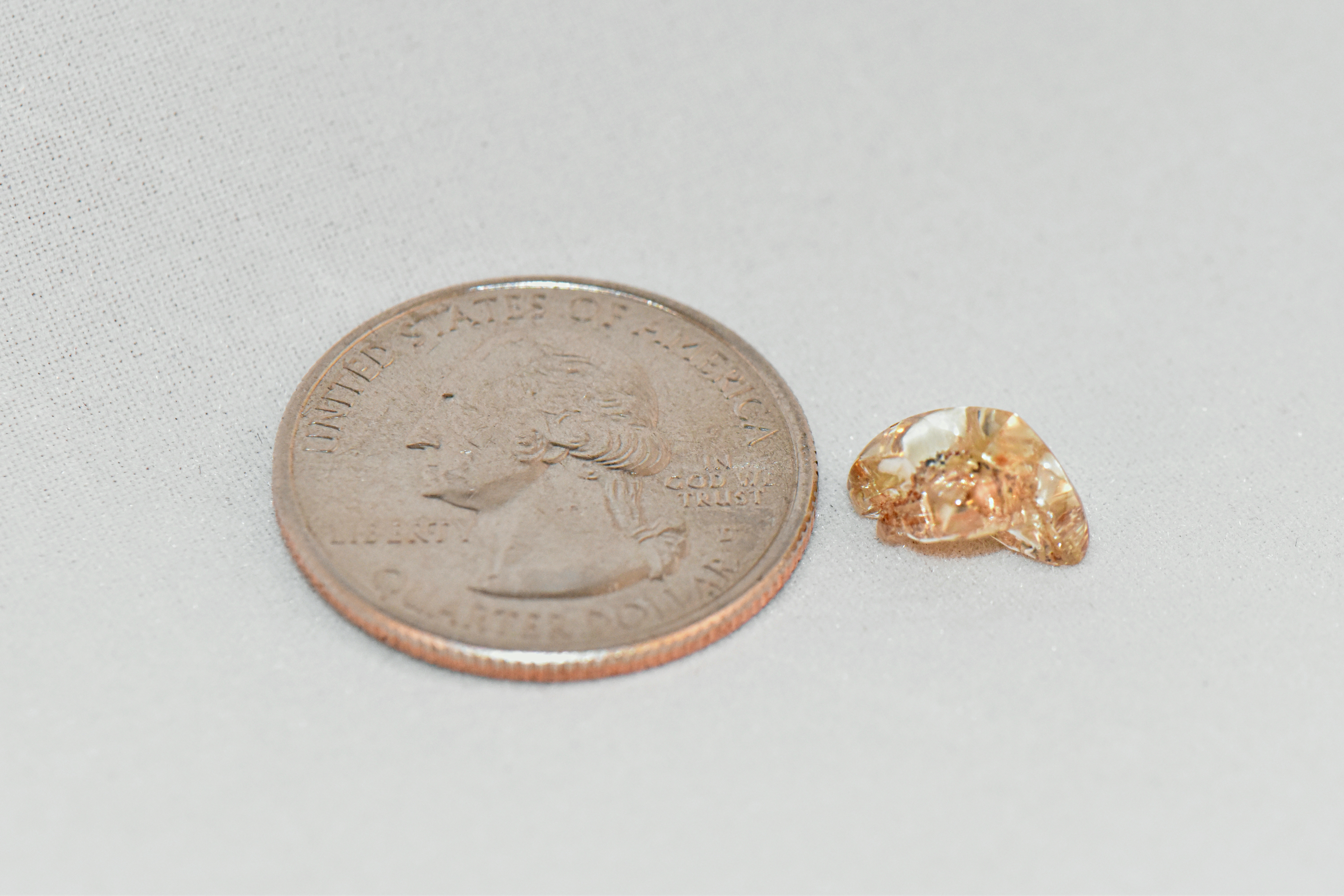 Miranda Hollingshead's 3.72-carat yellow diamond next to a quarter to show size and scale