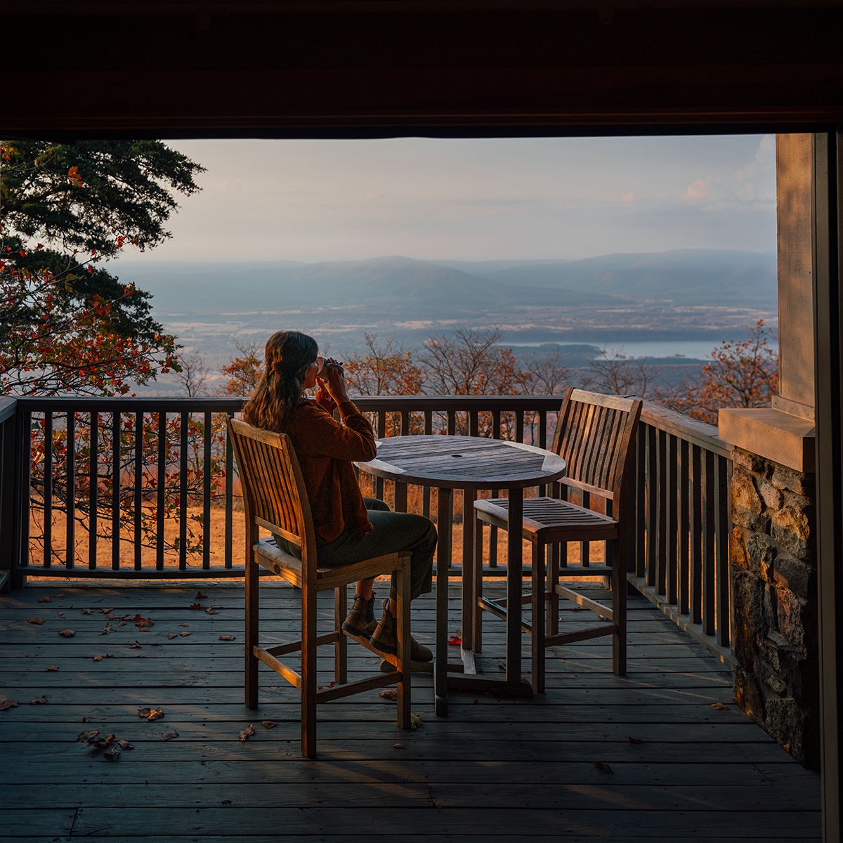 Lady sipping coffee at a Mount Magazine overlook
