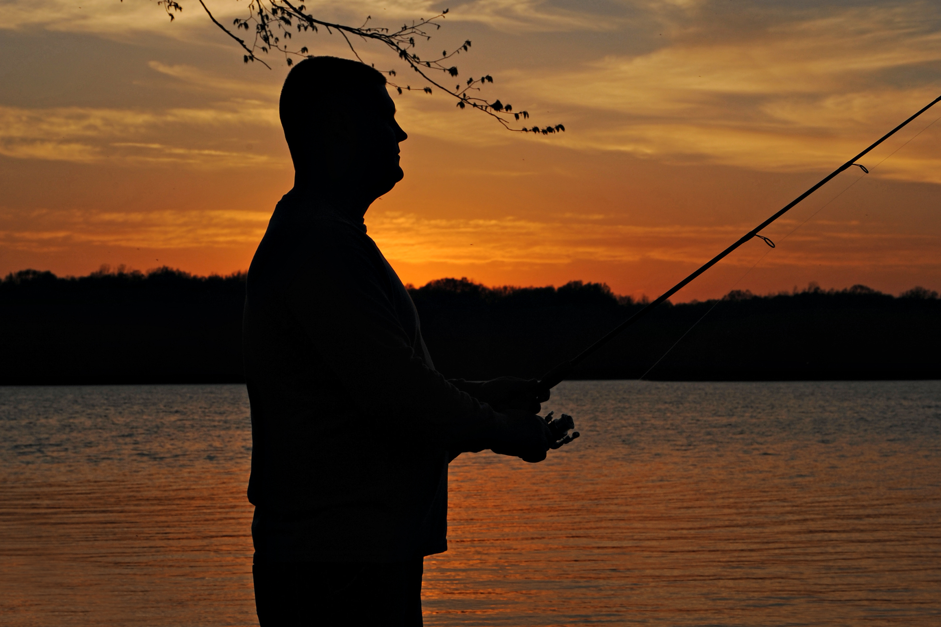 Fisher angling at sunset at Lake Frierson State Park