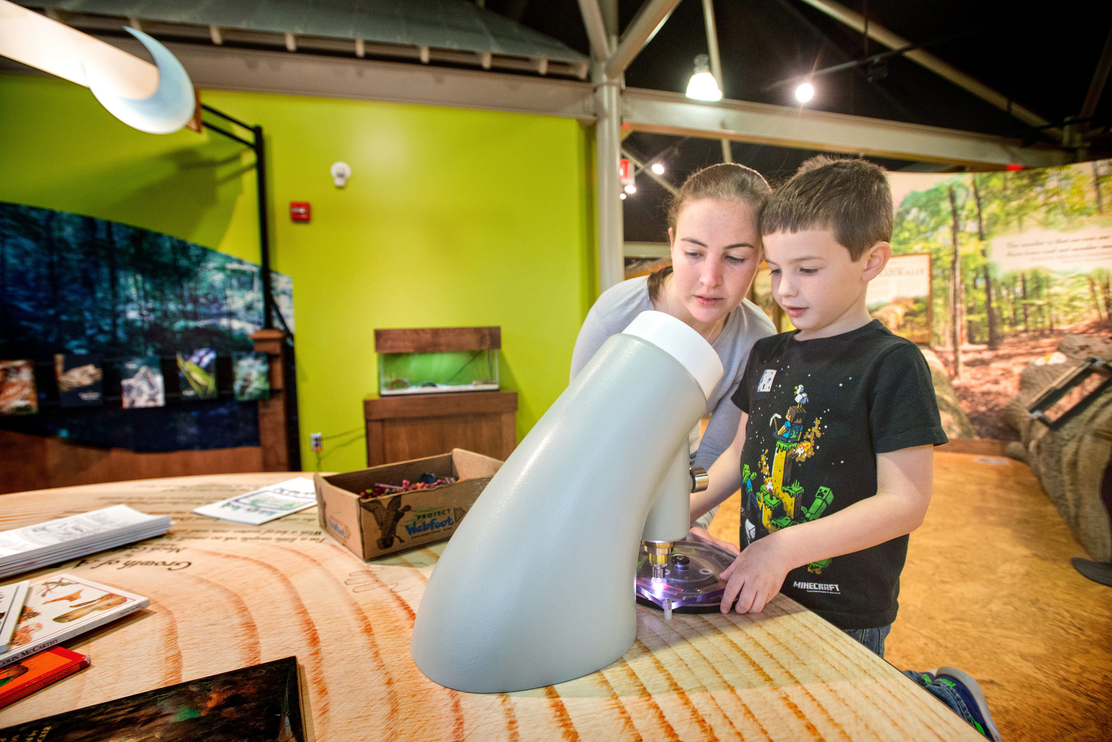 Two children interacting with the displays inside Logoly State Park