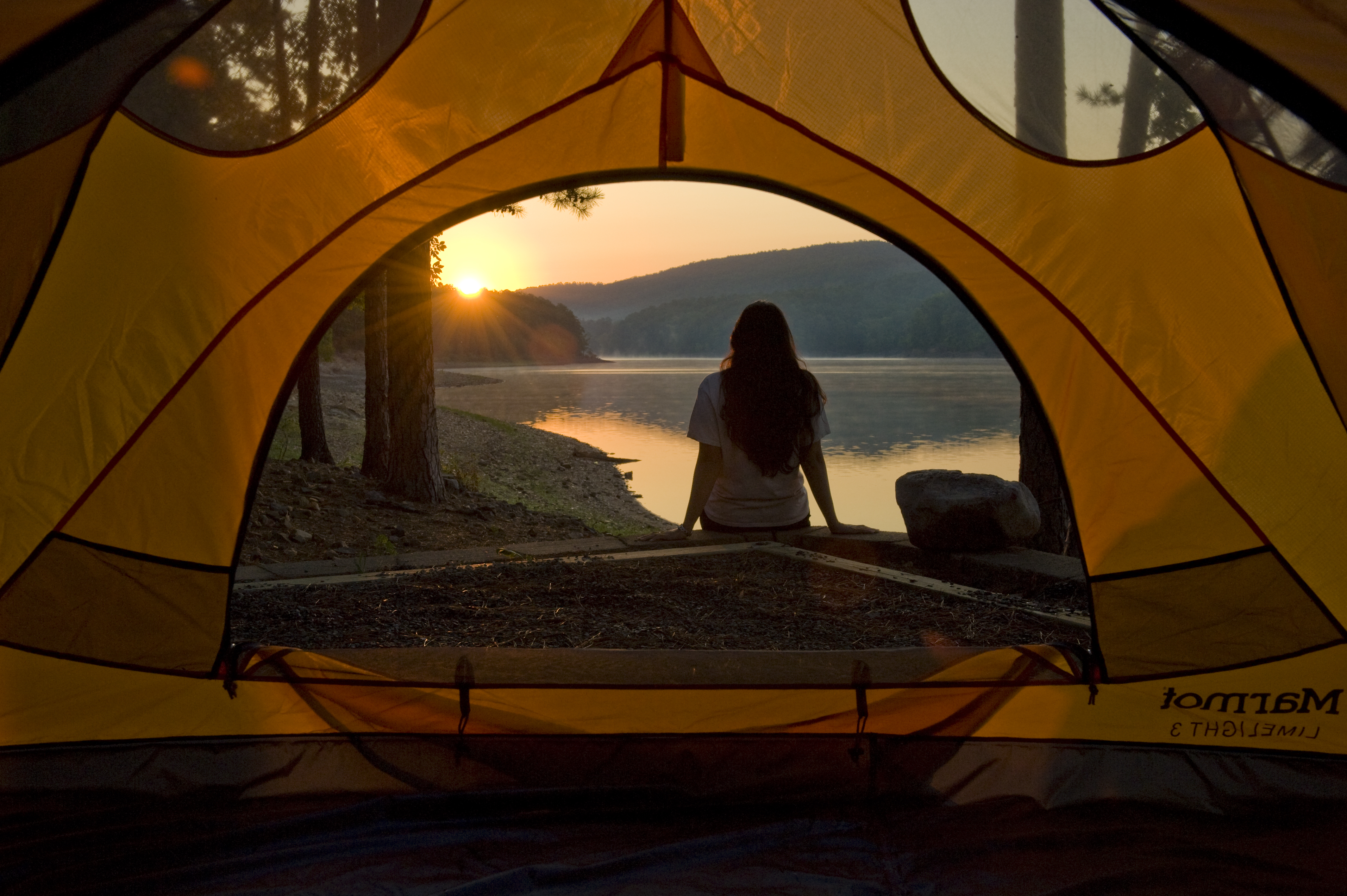 Camper overlooks Lake Ouachita at a campsite right on the shore of the lake