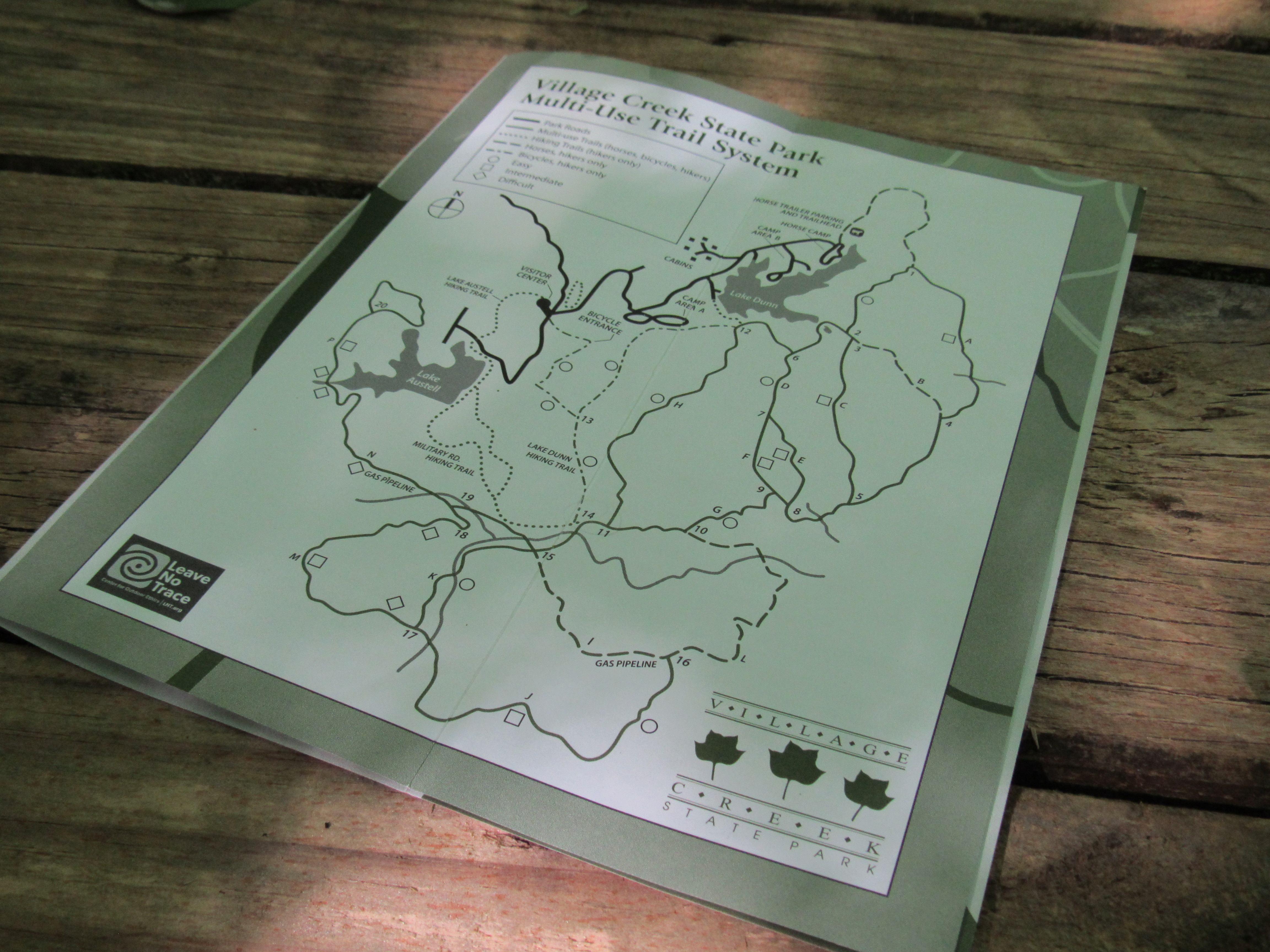 Park trail map displayed on a wooden box. 