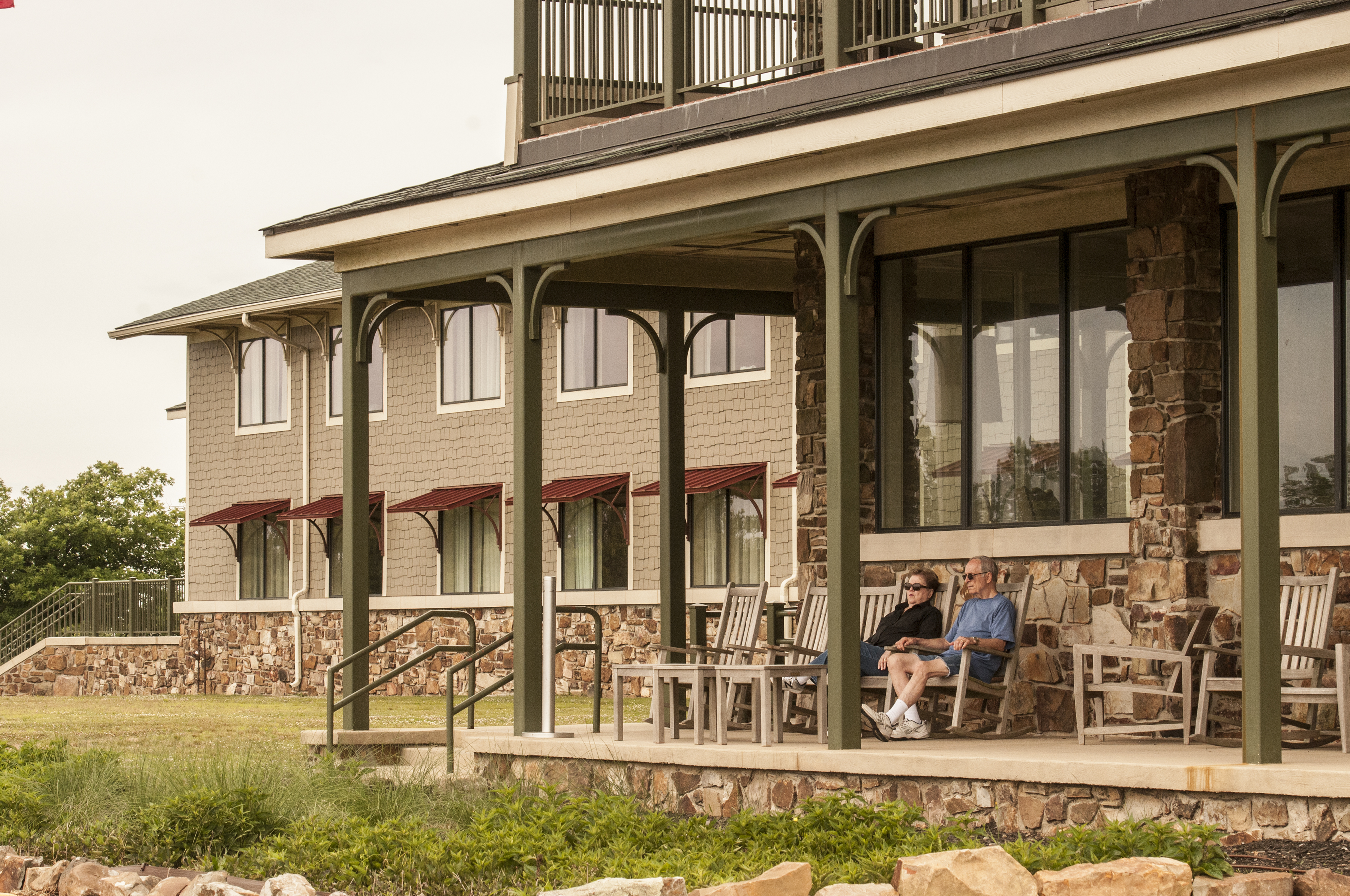 Couple sitting on the deck of Queen Wilhelmina Lodge