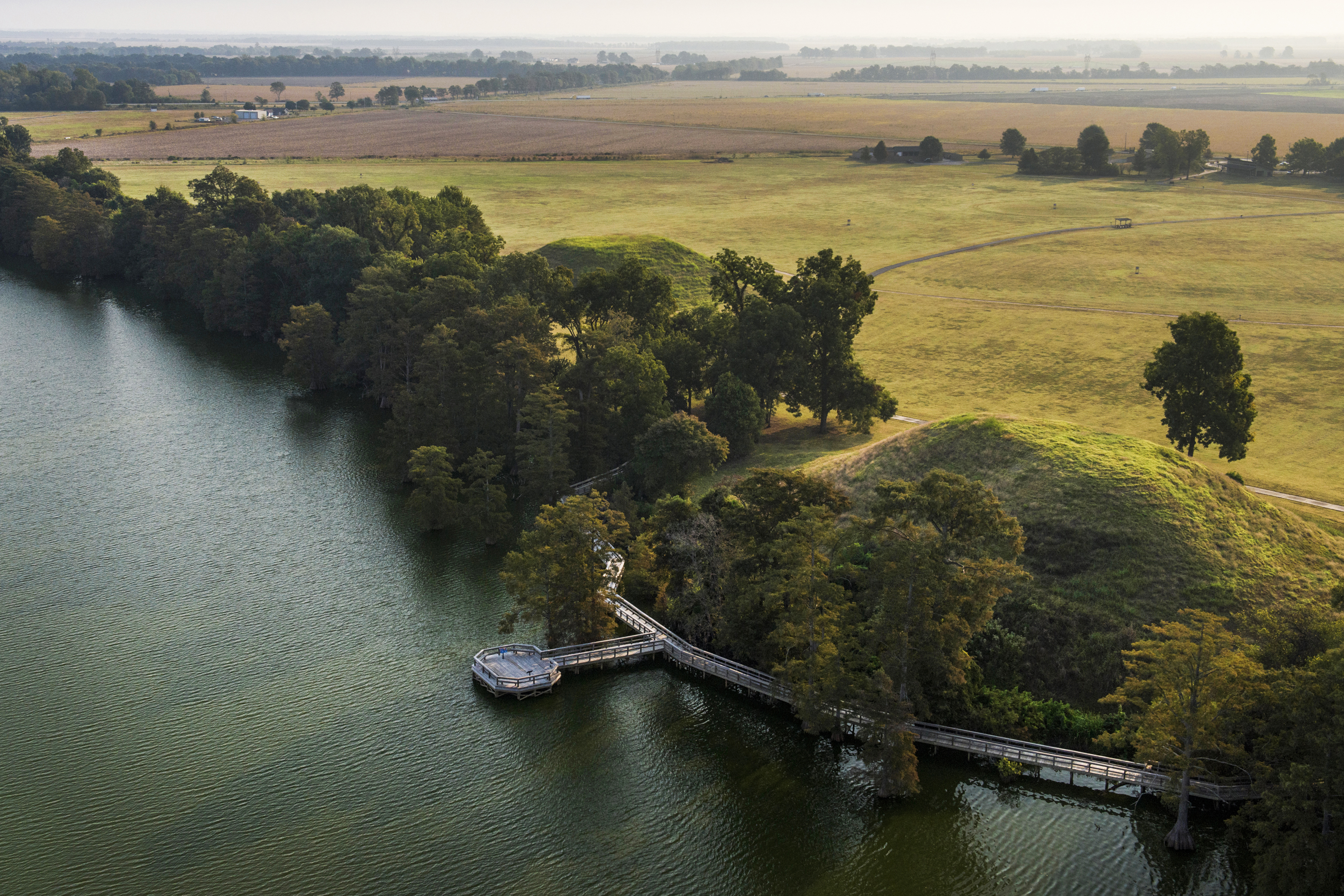 Plum Bayou Mounds surrounded by a lake and trees