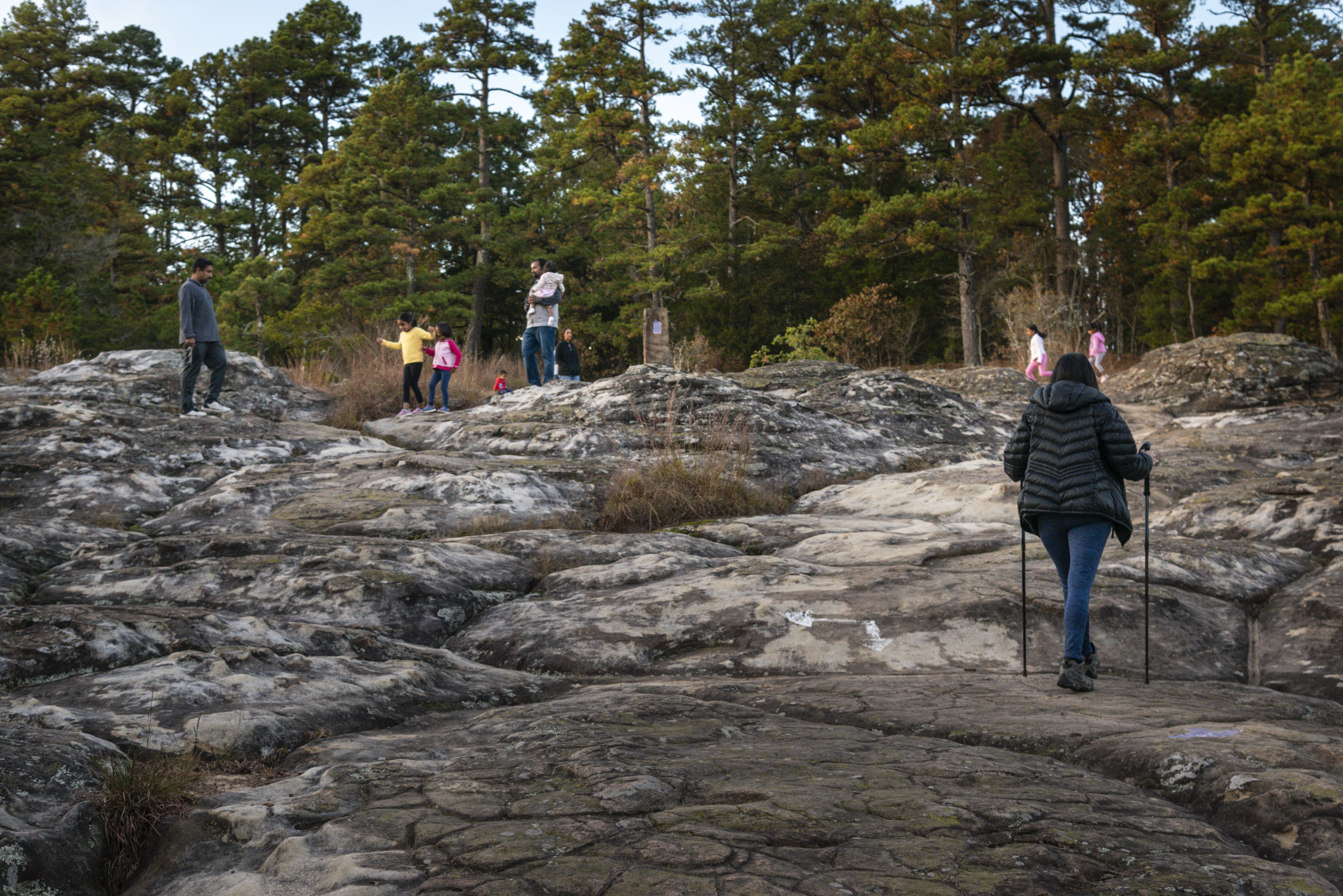 Family hiking on the "turtle rocks" at Petit Jean state park