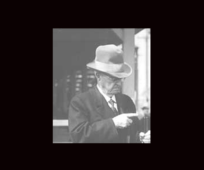 Black and white photo of Fred Kimble holding a shotgun 