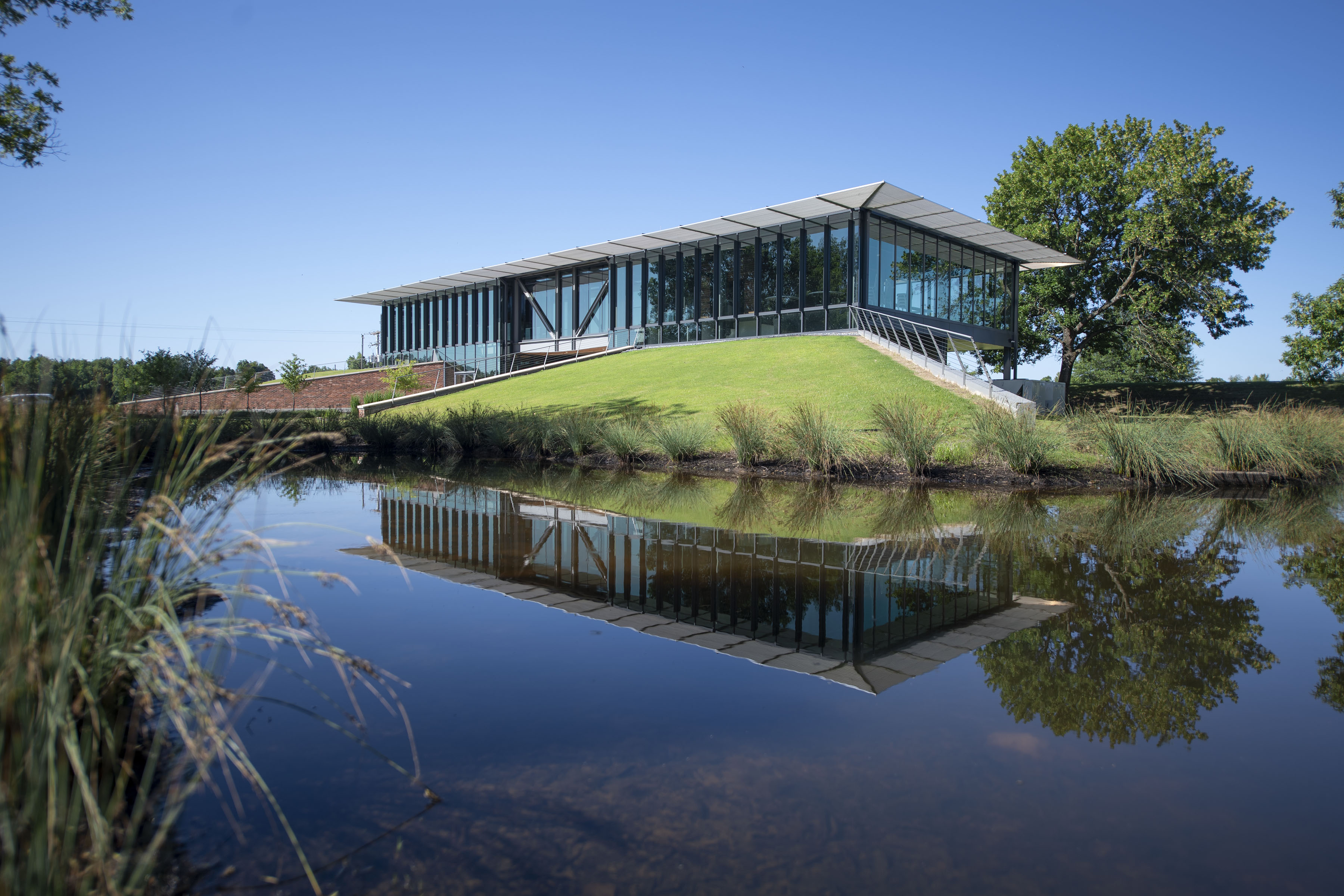  new visitor center, completed in 2019, facing the White River. A full reflection of the building appears in the water at foreground of image