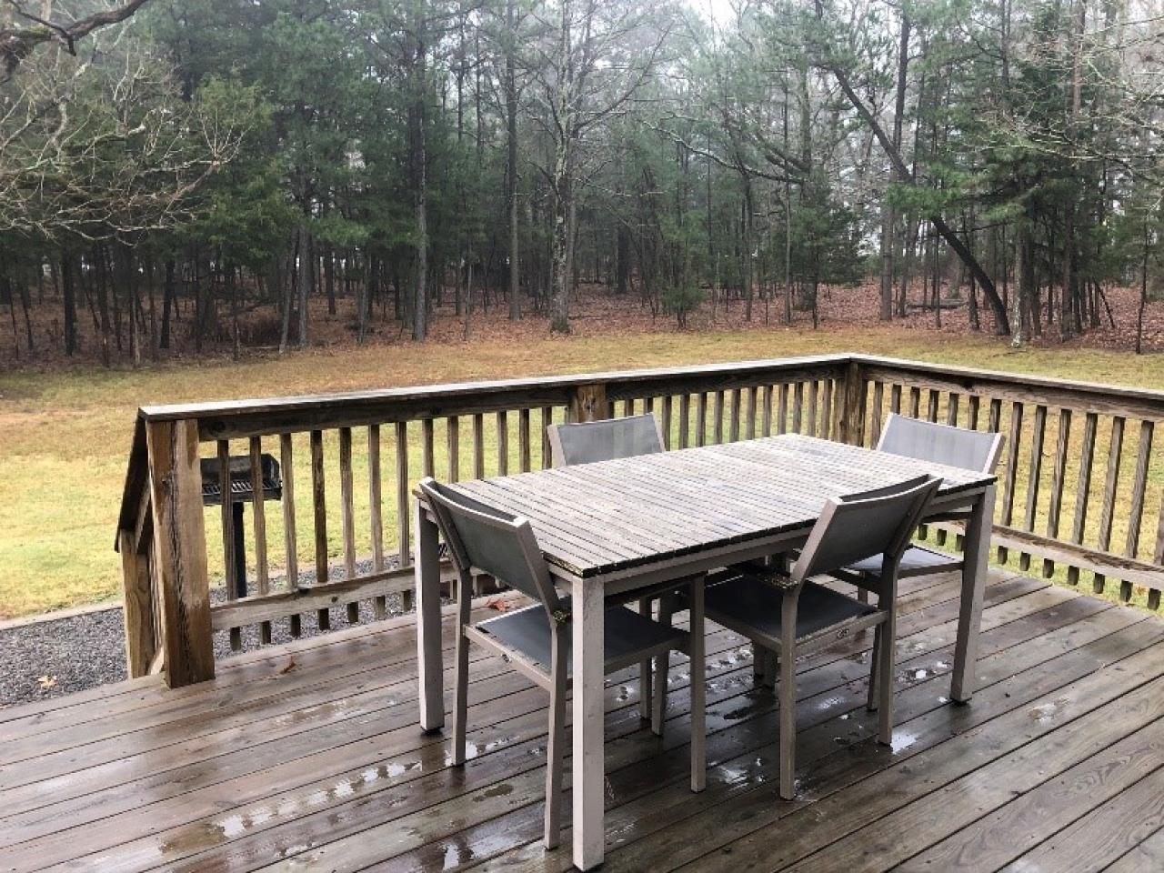 A view of the outdoor seating on the back deck of Cabin 1 at Mount Nebo State Park