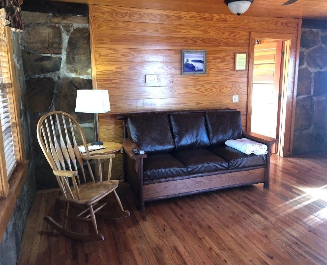 A couch and rocking chair in the living room in Cabin 3 at Mount Nebo State Park