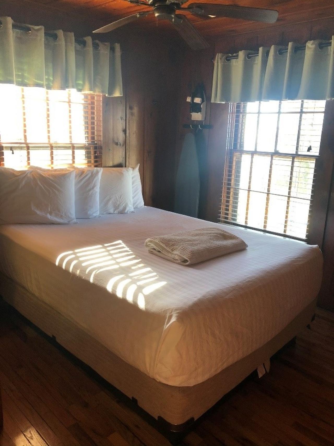 A view of the bed in the bedroom in Cabin 4 at Mount Nebo State Park