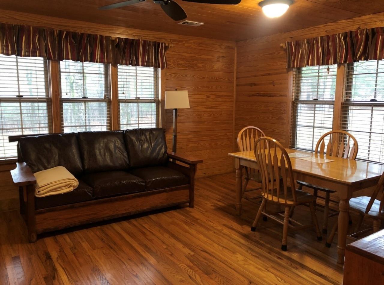 A view of the couch and dining room table in the living room/dining room at Cabin 5 at Mount Nebo State Park