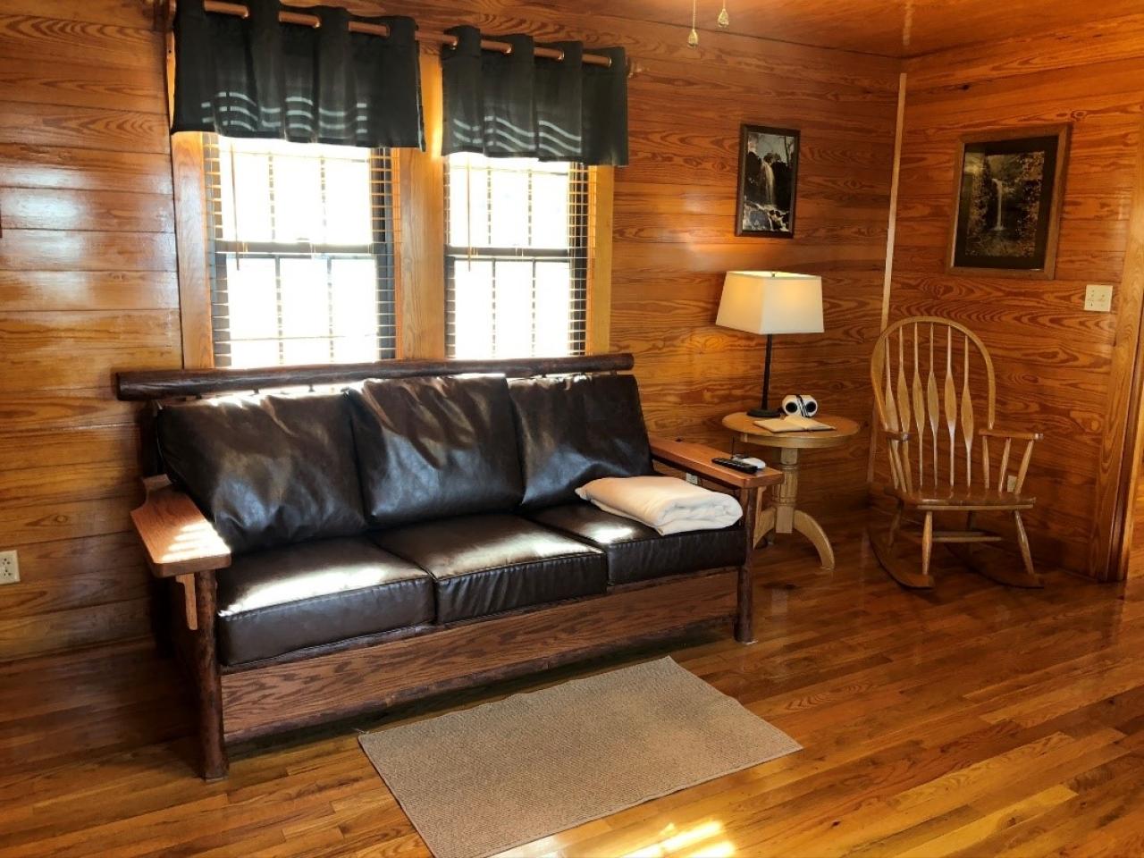 A view of the couch and rocking chair in the living room at Cabin 9 at Mount Nebo State Park