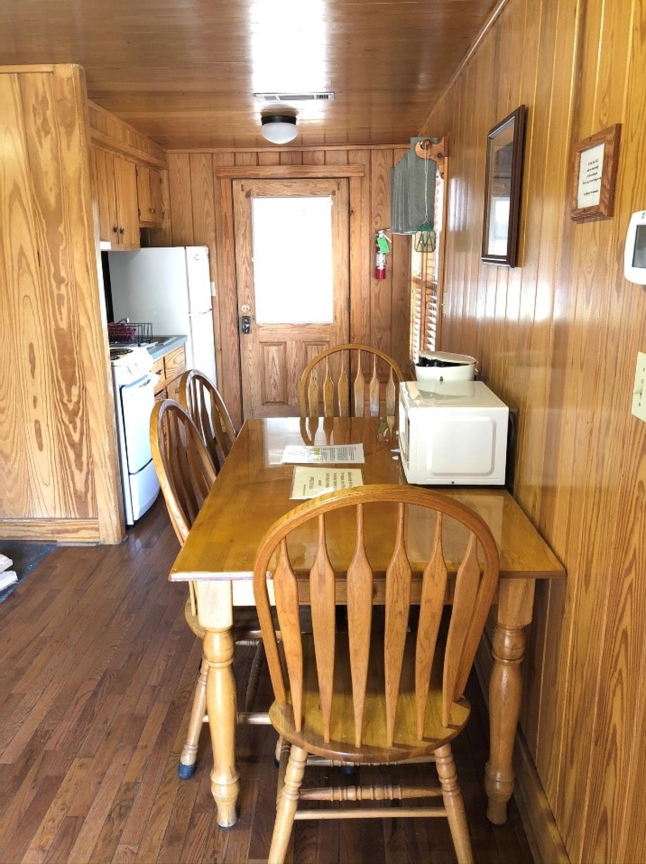 A view of the dining area and kitchen at Cabin 13 at Mount Nebo State Park