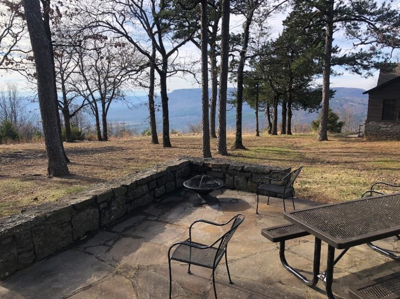 A view of the outdoor seating area and firepit at Cabin 13 at Mount Nebo State Park