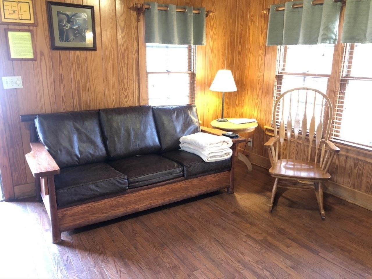 The couch and rocking chair in the living room at Cabin 14 at Mount Nebo State Park