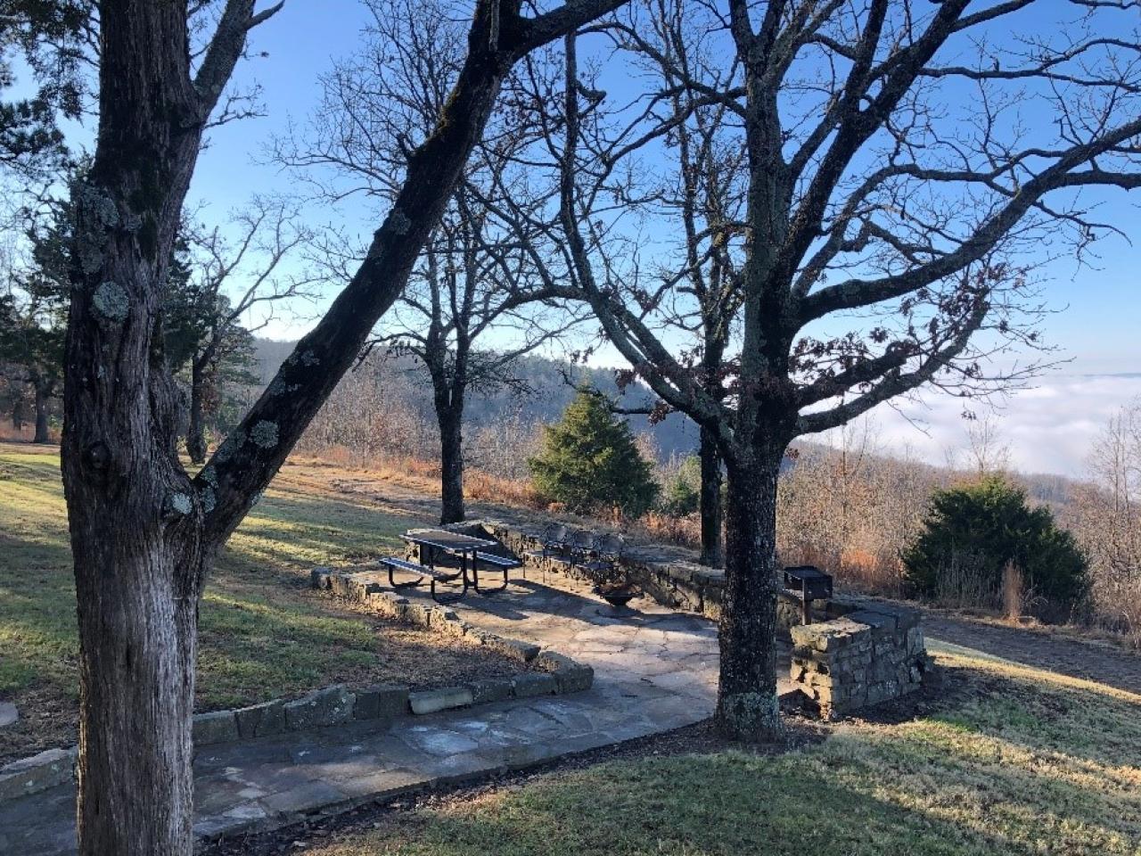 A view of the outdoor seating area, outdoor grill and view at Cabin 15 at Mount Nebo State Park