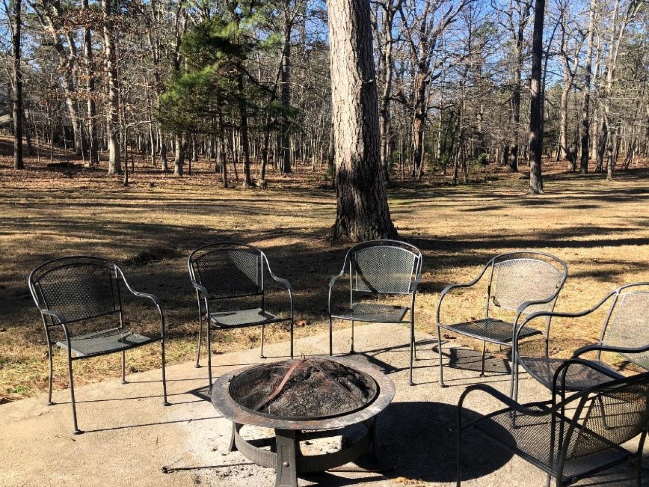 A view of the outdoor seating area and firepit at Cabin 7 at Mount Nebo State Park