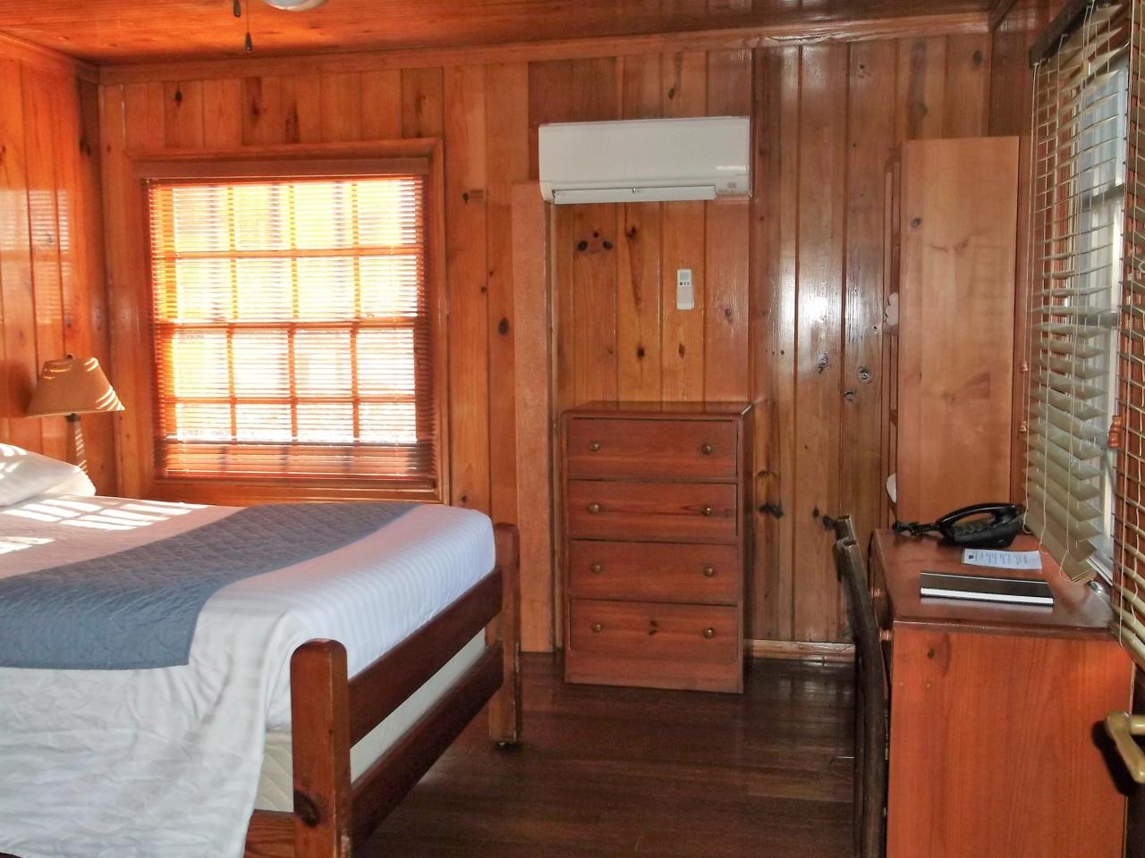 View of bedroom including bed, dresser, desk and ac unit