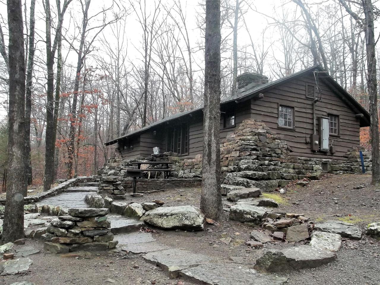 An exterior view of cabin 11 showing the stone staircase leading to the front door with outdoor seating area