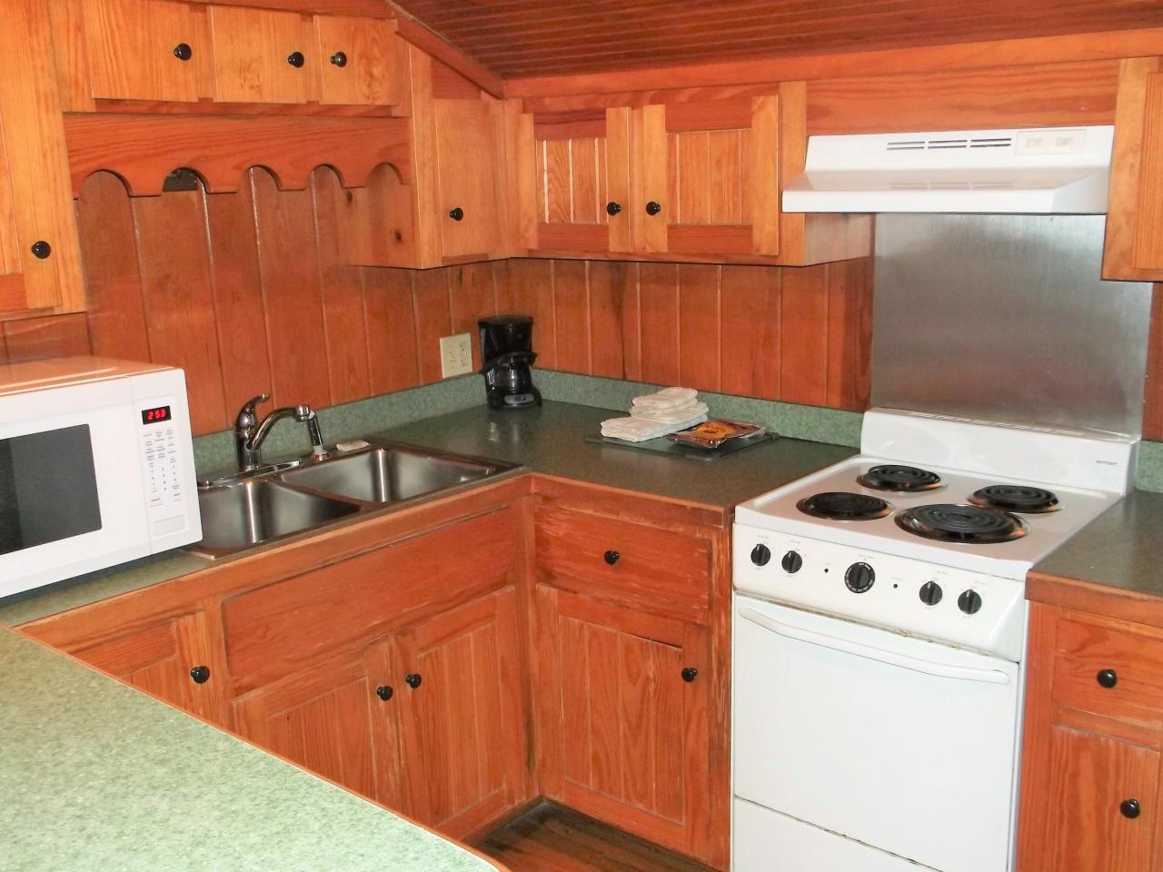A view of the kitchen in cabin 16 including a small oven, microwave and double sink