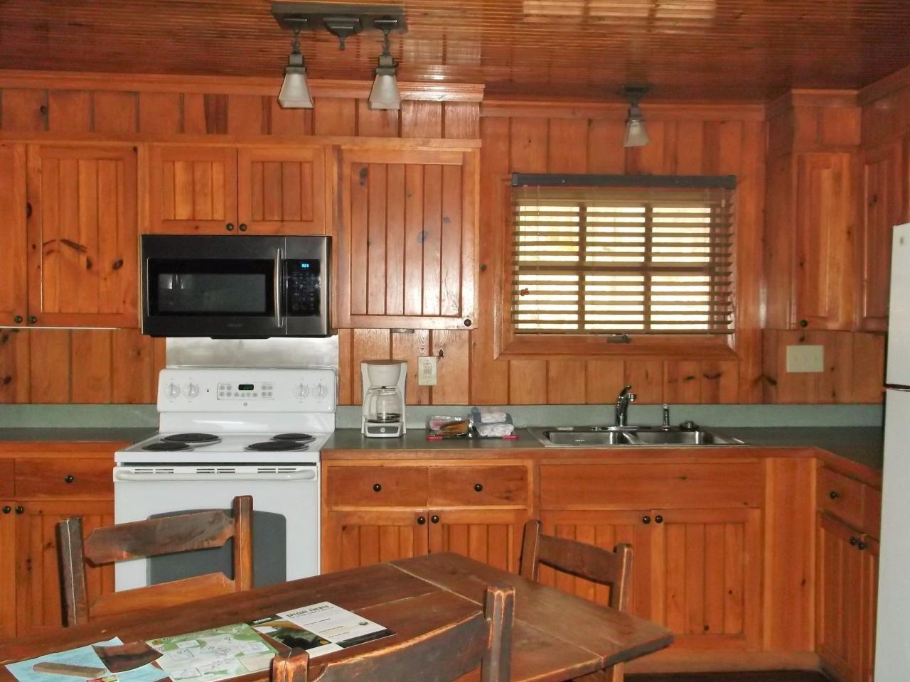 View of the kitchen with oven, microwave double sink and dining table