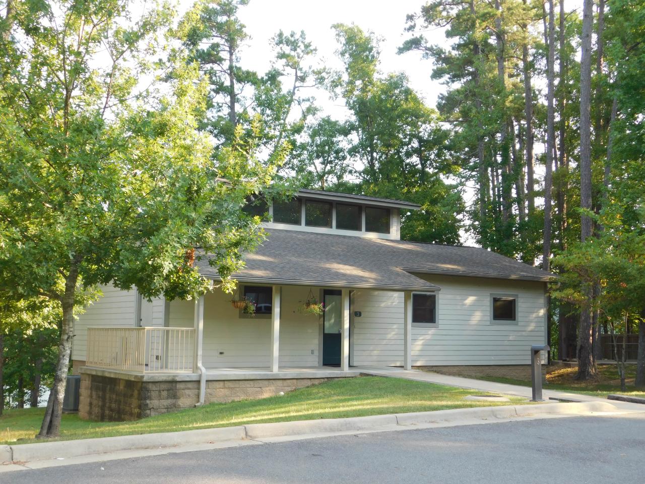 An exterior view of Cabin 3 at Lake Ouachita State Park including a front porch area
