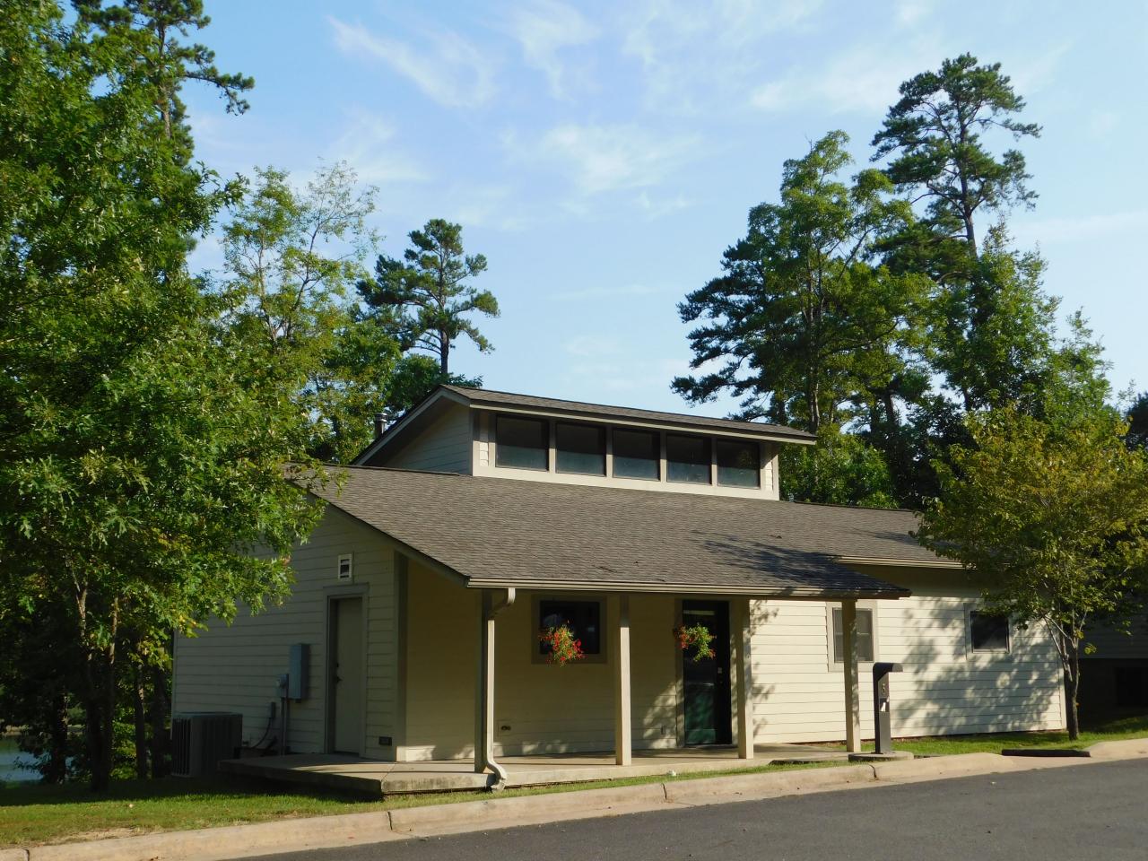 An exterior view of Cabin 5 at Lake Ouachita State Park including a front porch area