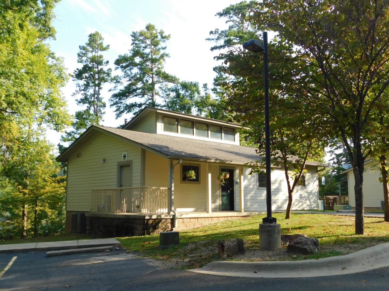 An exterior view of Cabin 6 at Lake Ouachita State Park including a front porch area