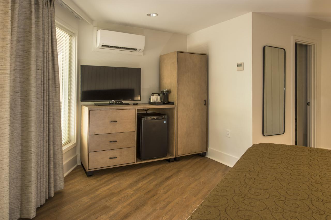 A view of the tv, mini-fridge, dresser and tv in the Standard Suite in Ozark Folk Center State Park