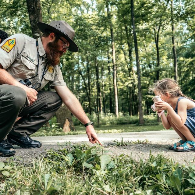 Kid and park ranger taking a photo