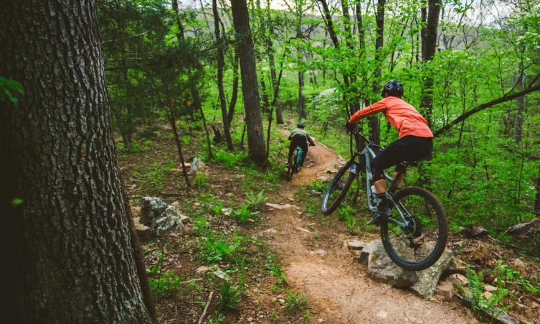Two mountain bikers riding the monument trails at Devil's Den State Park