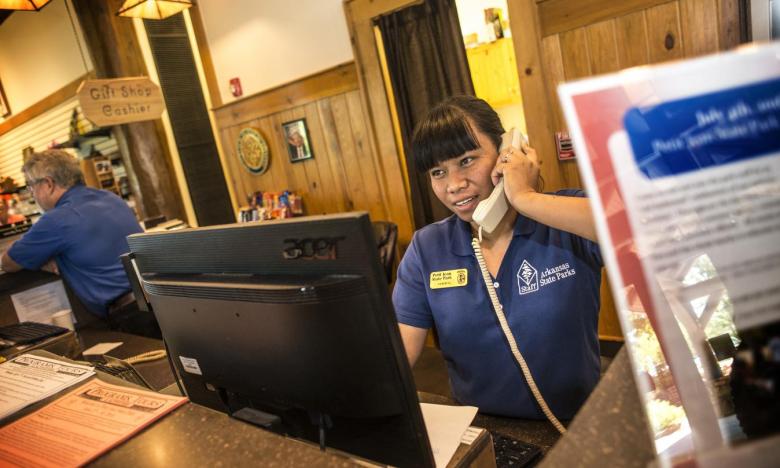 A friendly staff member at the Petit Jean State Park helping visitors