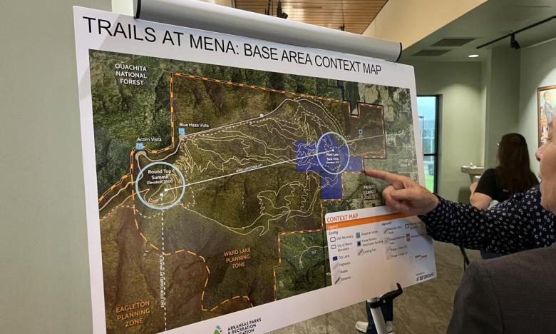 Event attendees check out a context map for the Trails at Mena project. 