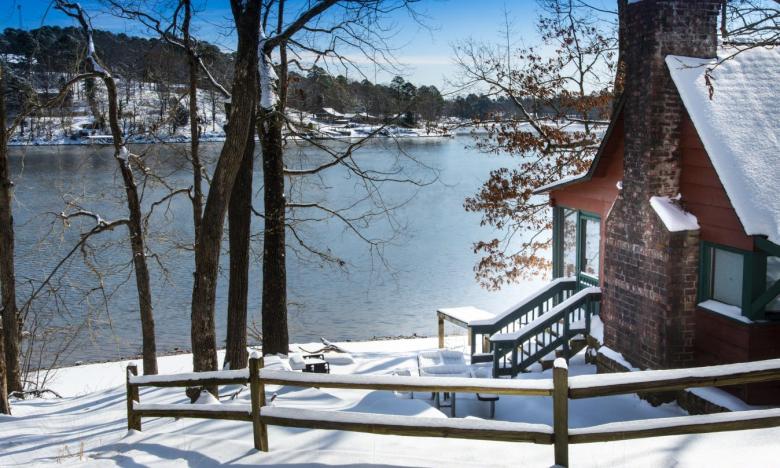 Cabin in snow at Lake Catherine State Park. 