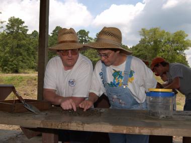 Couple water sifting for diamonds