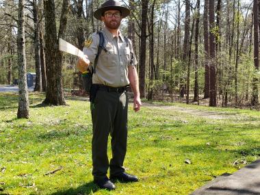 Park interpreter Matthew holding a stick showing six feet distance