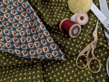 Dress material with thread and sewing scissors