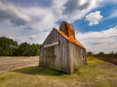 Ozark Diamond Mine shack that sits on the diamond search field with blue skies and white clouds overhead