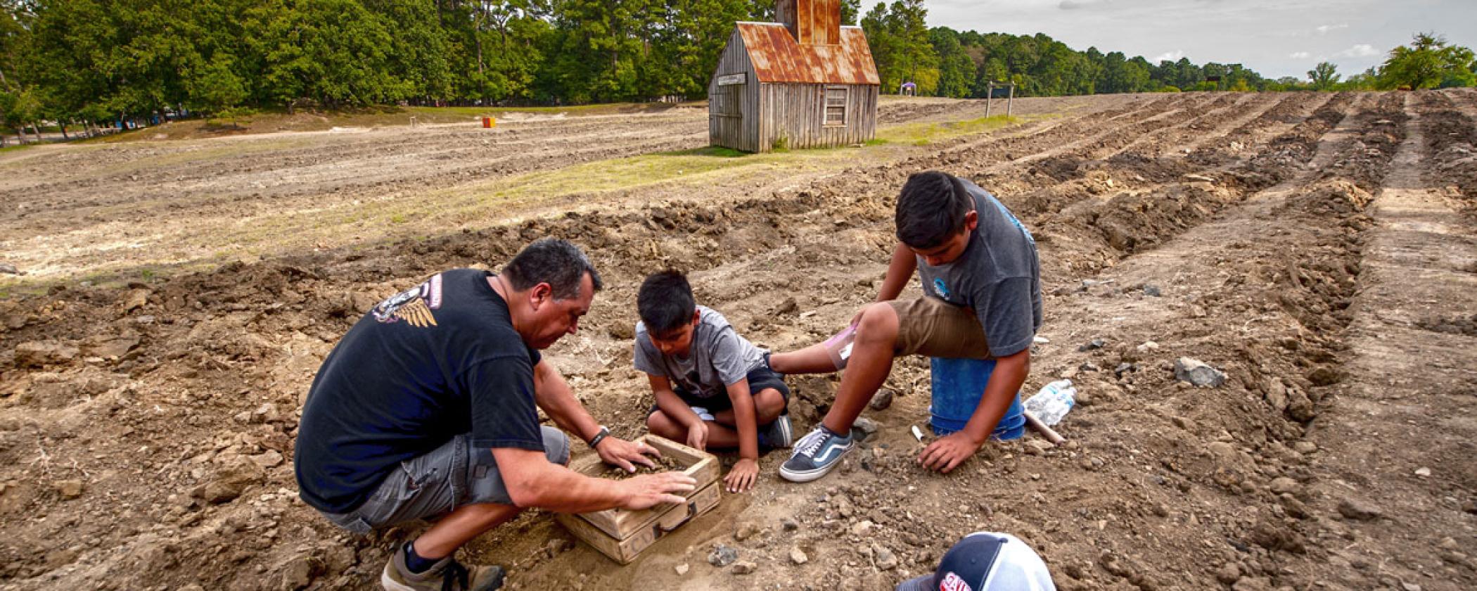 Family digging for gems at Crater of Diamonds State Park