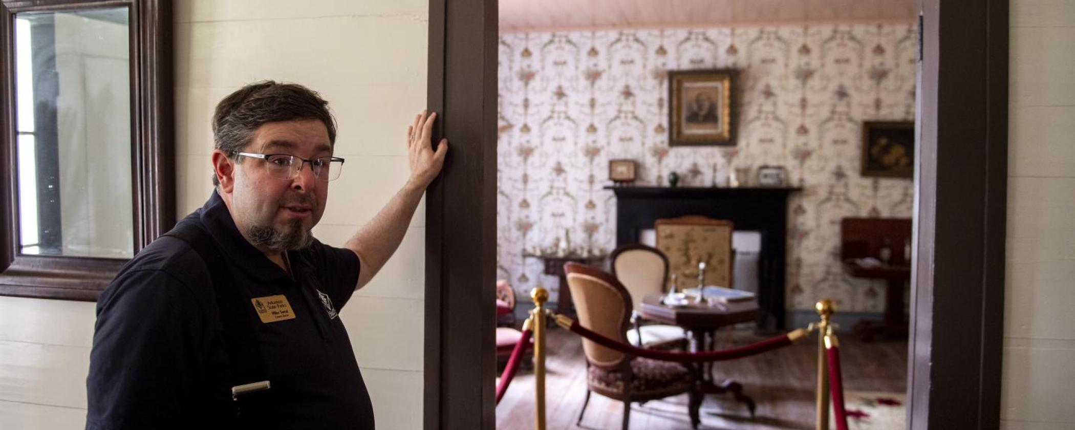 A tour guide showing a bedroom during a tour at Historic Washington State Park