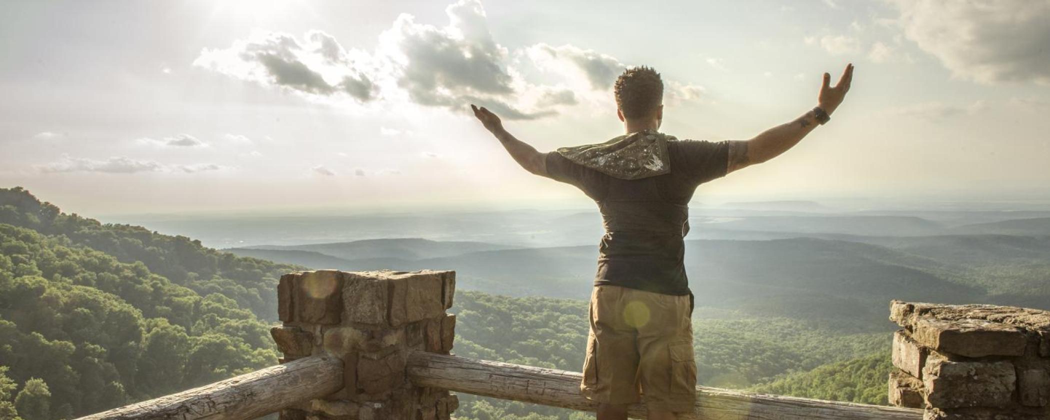 A visitor looks out over the vista at Mount Magazine State Park