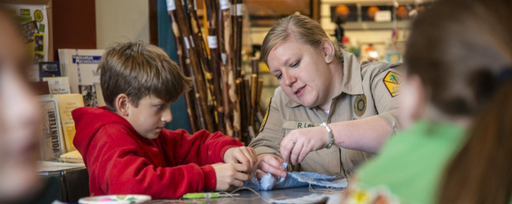 A park interpreter leads a hands on workshop at Parkin Archeological State Park